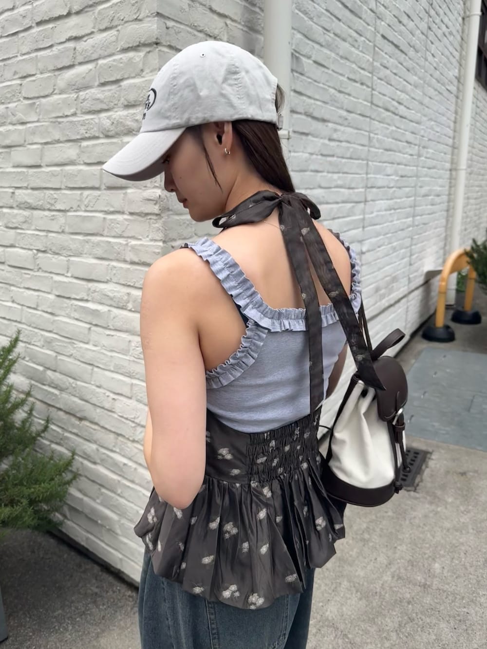 ブラック系のシャツ/ブラウス、ホワイト系のキャップを着用したレディースの春コーディネートの5枚目の写真