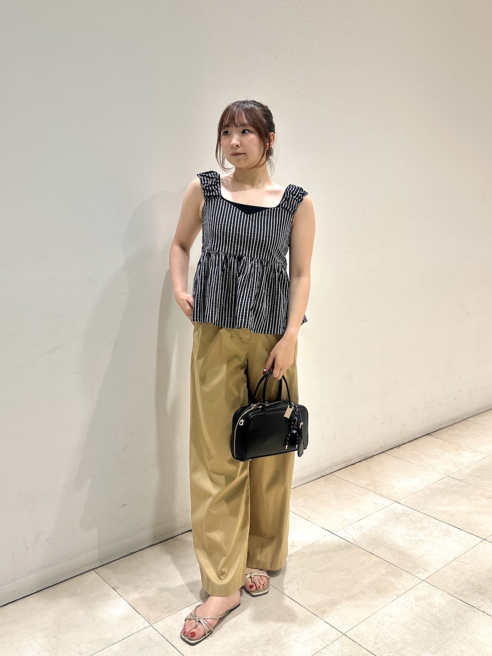 ブラック系のシャツ/ブラウス、ベージュ系のその他パンツ、ブラック系のボストンバッグを着用したレディースの夏コーディネートの4枚目の写真