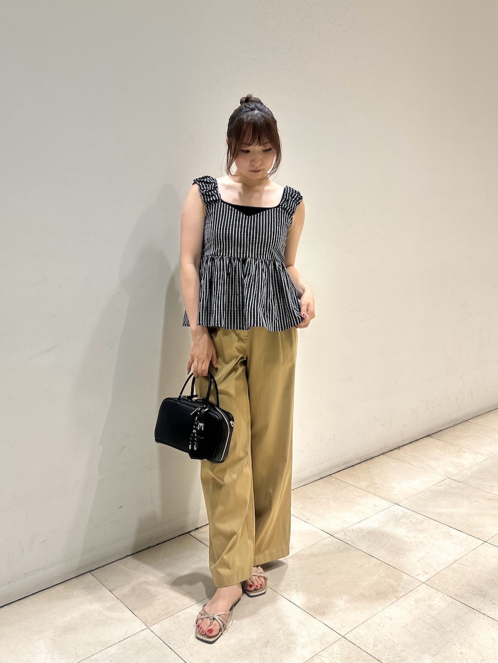 ブラック系のシャツ/ブラウス、ベージュ系のその他パンツ、ブラック系のボストンバッグを着用したレディースの夏コーディネートの2枚目の写真