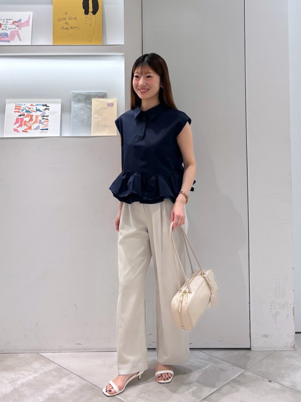 ブルー系のシャツ/ブラウス、ベージュ系のその他パンツ、ホワイト系のボストンバッグを着用したレディースの夏コーディネートの2枚目の写真