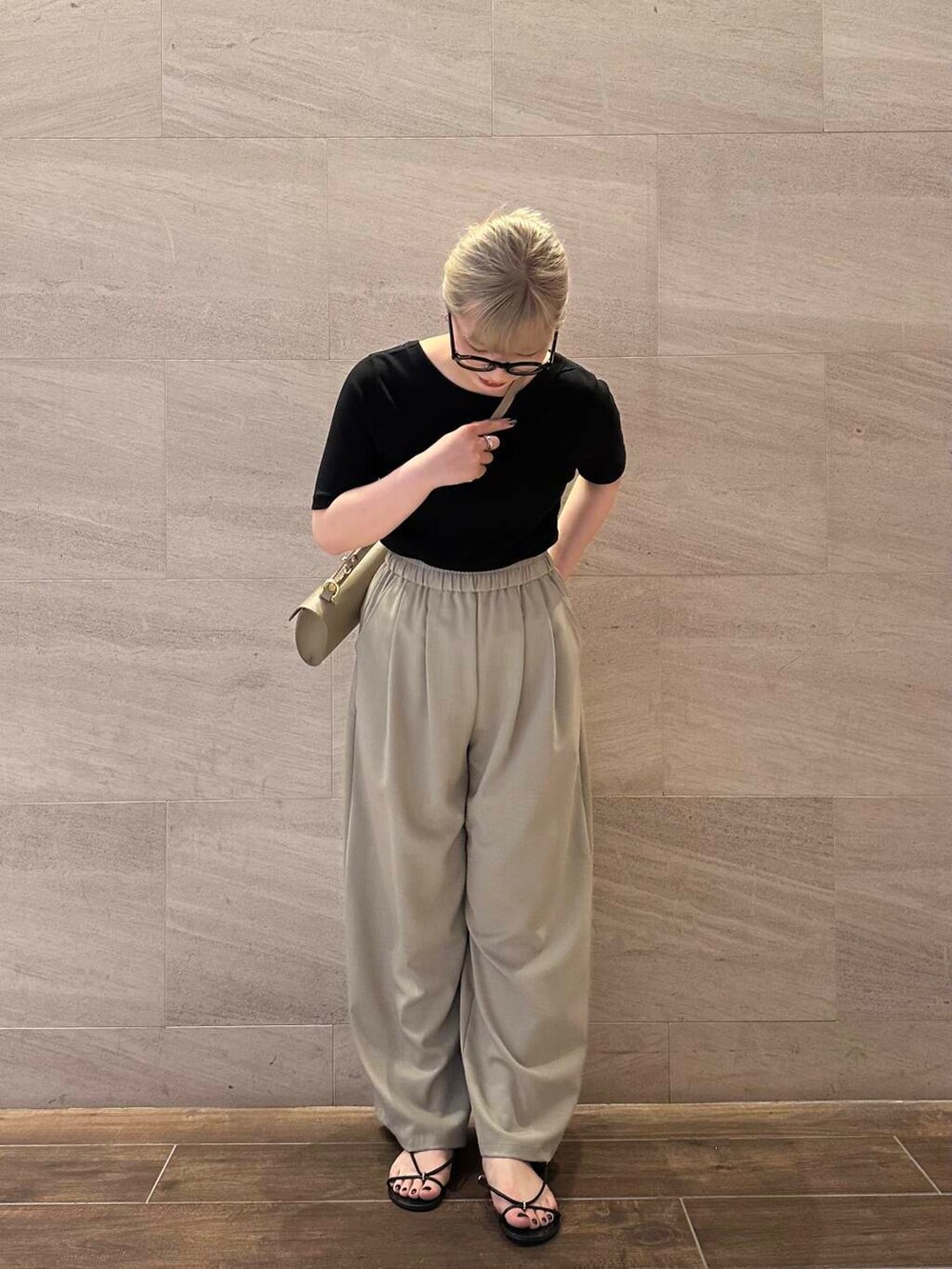 ベージュ系のその他パンツ、ベージュ系のショルダーバッグ、ブラック系のTシャツ/カットソーを着用したレディースの夏コーディネートの6枚目の写真