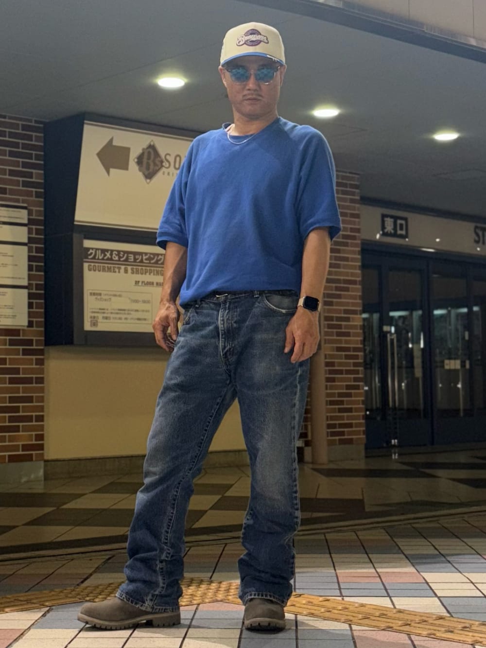 グレー系のブーツ、ブルー系のデニムパンツ、ブルー系のスウェットを着用したメンズの夏コーディネートの2枚目の写真