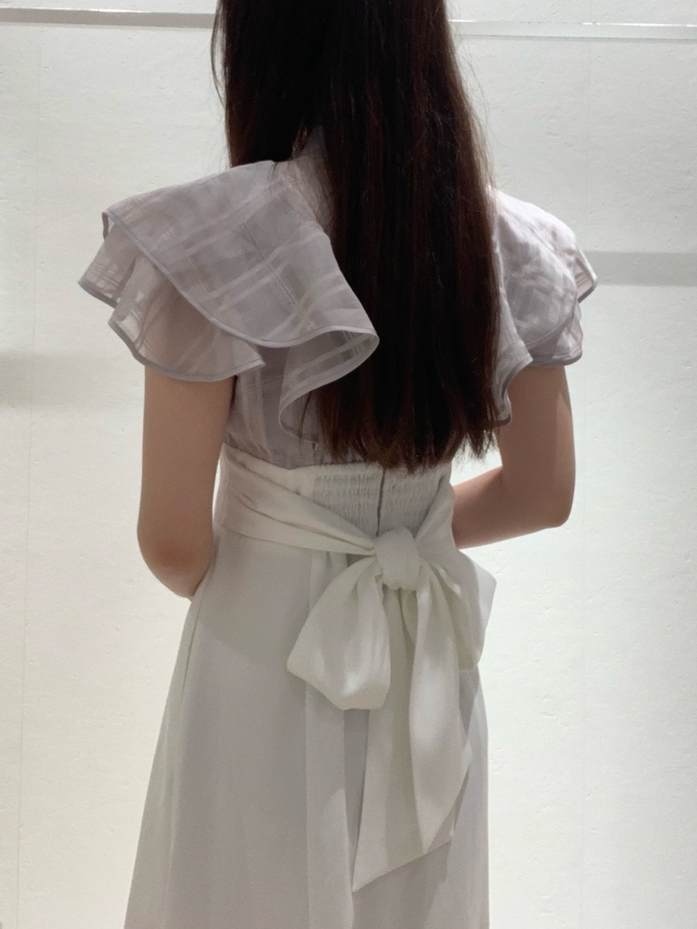 パープル系のワンピース、ピンク系のショルダーバッグ、ホワイト系のサンダルを着用したレディースの夏コーディネートの4枚目の写真