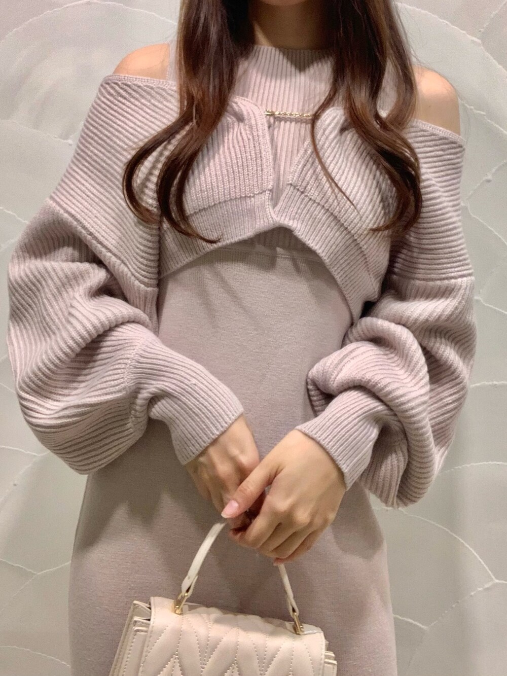 ピンク系のワンピース、ホワイト系のショルダーバッグ、ホワイト系のブーツを着用したレディースの秋コーディネートの5枚目の写真