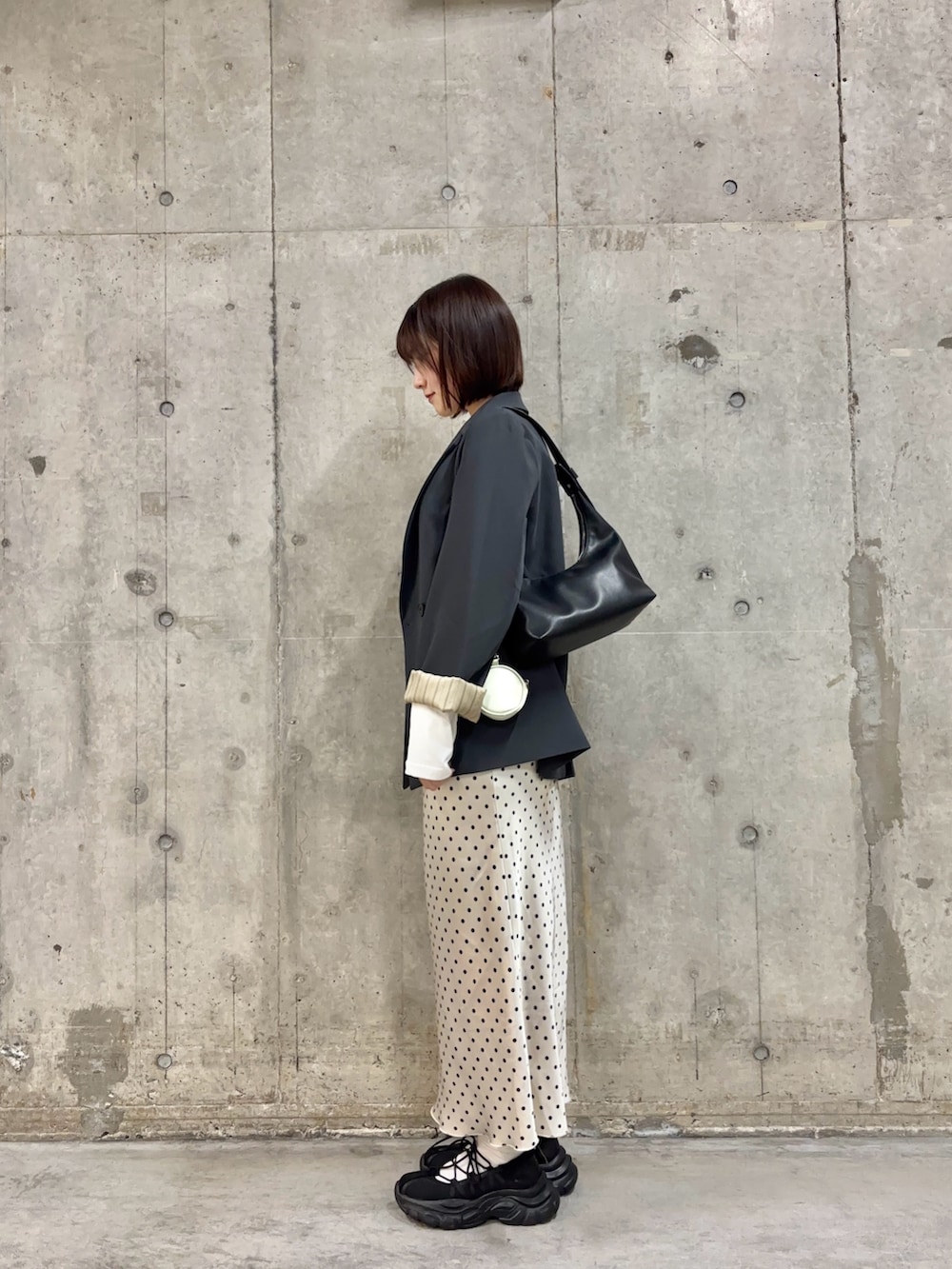 グレー系のテーラードジャケット、ホワイト系のTシャツ/カットソー、ホワイト系のスカートを着用したレディースの春コーディネートの3枚目の写真