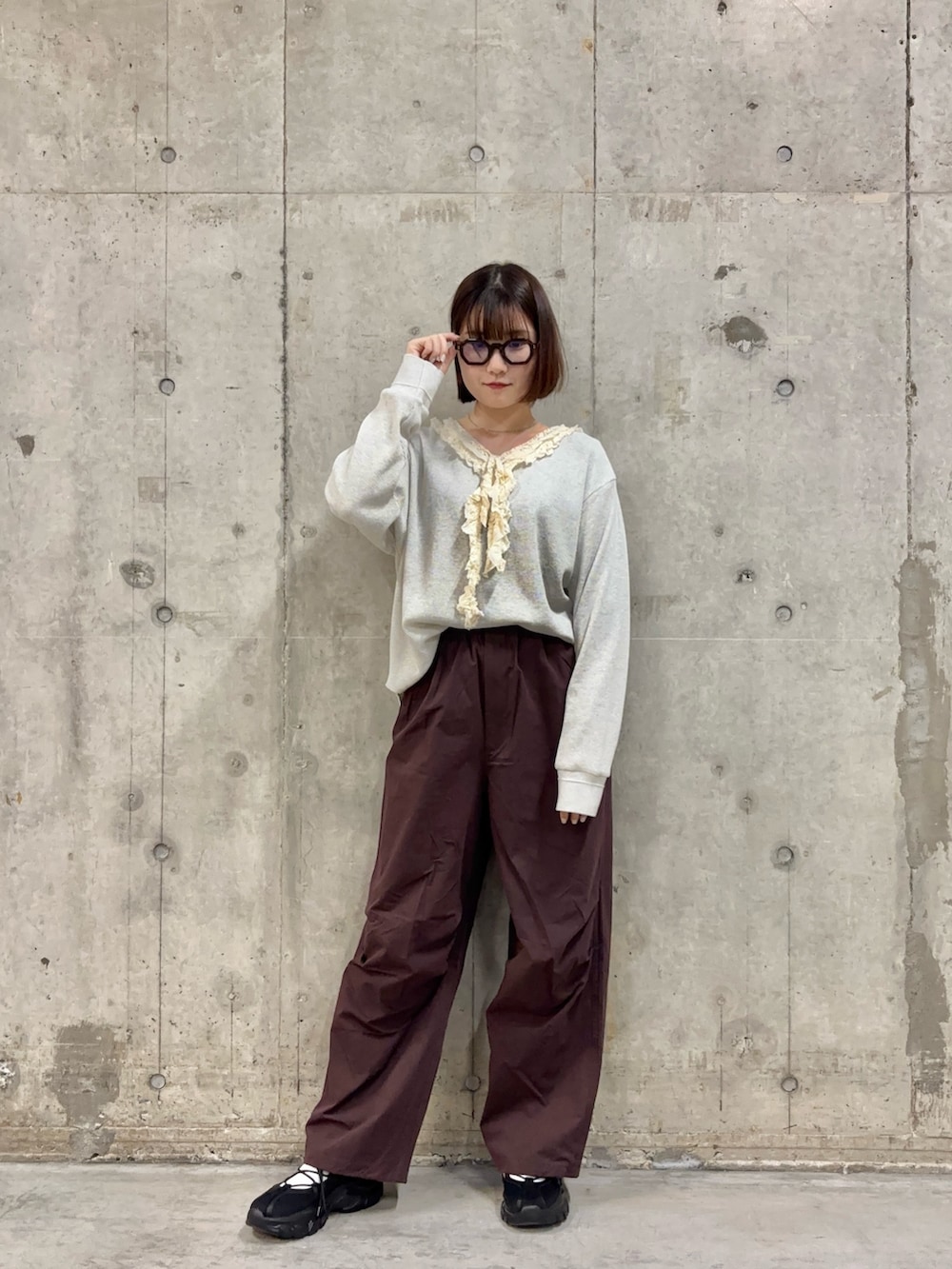 ブラウン系のその他パンツ、ベージュ系のTシャツ/カットソー、ブラック系のスニーカーを着用したレディースの春コーディネートの2枚目の写真