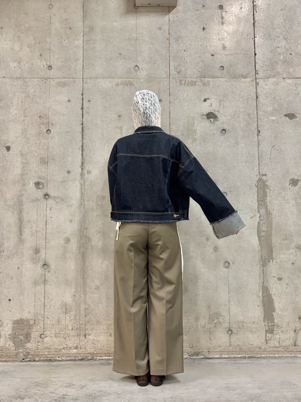 ブルー系のデニムジャケット、ホワイト系のその他トップス、グリーン系のスラックスを着用したレディースの春コーディネートの4枚目の写真