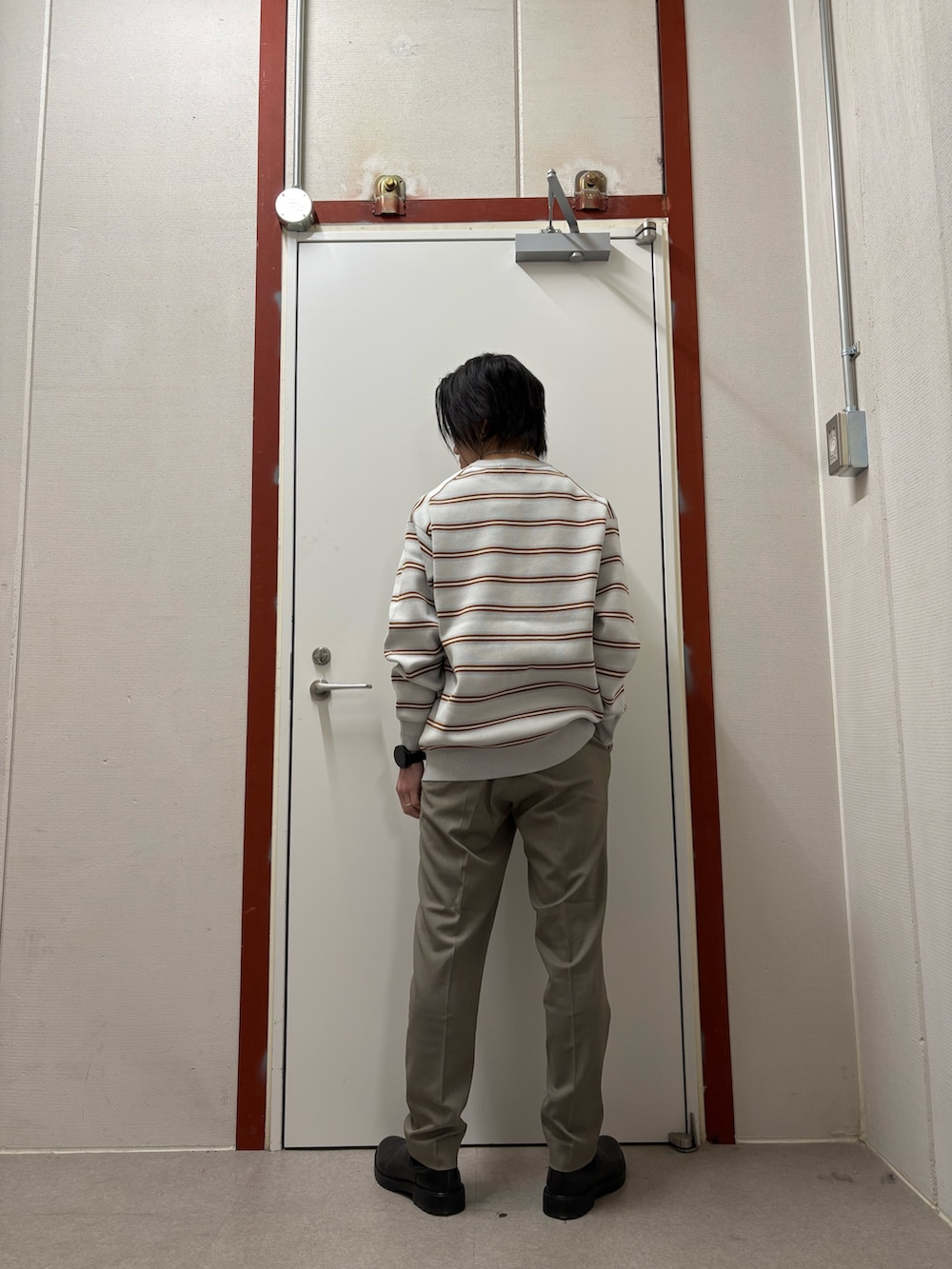 グレー系のニット/セーター、ベージュ系のその他パンツを着用したメンズの冬コーディネートの3枚目の写真