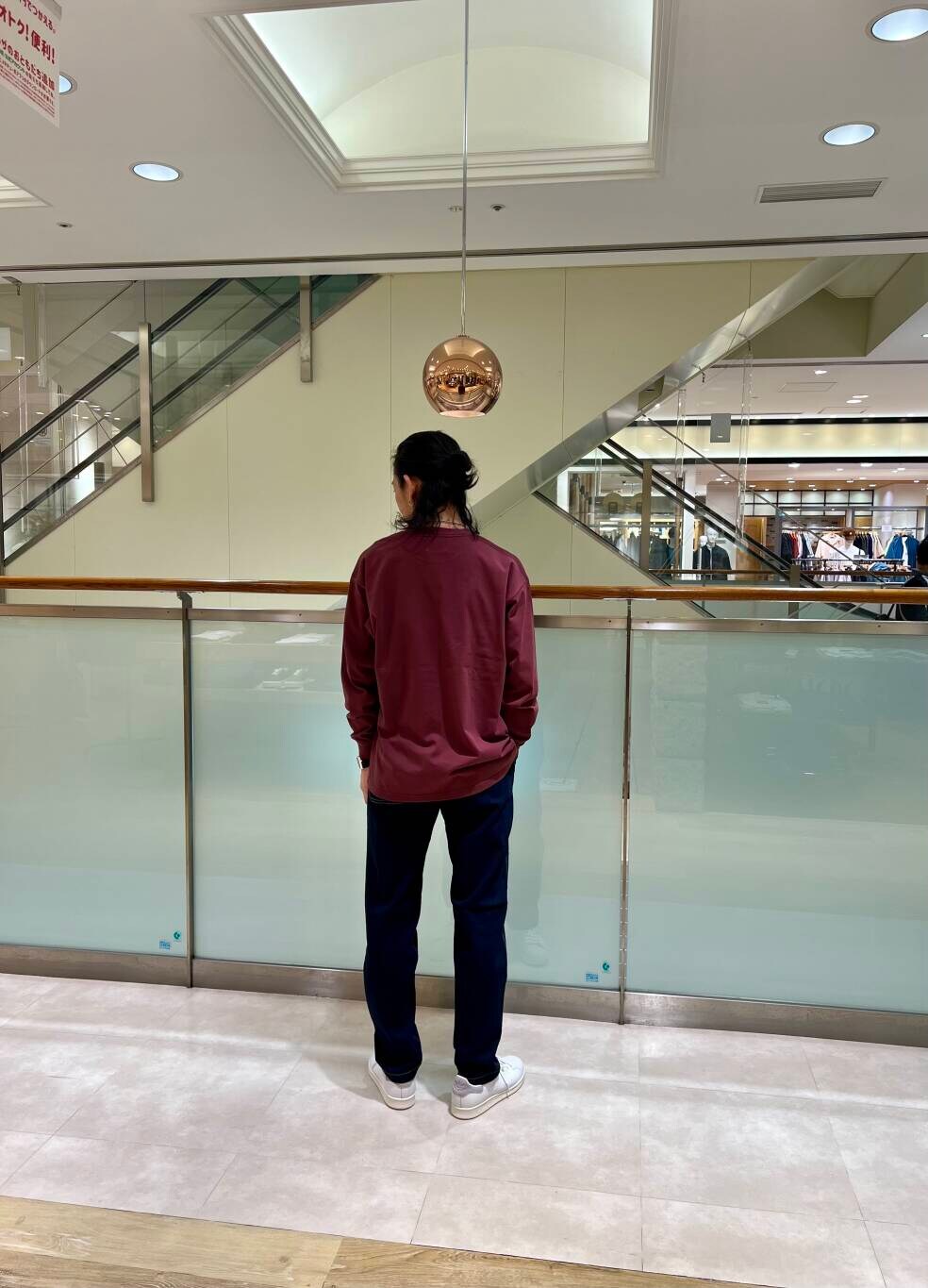 ホワイト系のスニーカー、ブルー系のデニムパンツ、レッド系のTシャツ/カットソーを着用したメンズの夏コーディネートの3枚目の写真