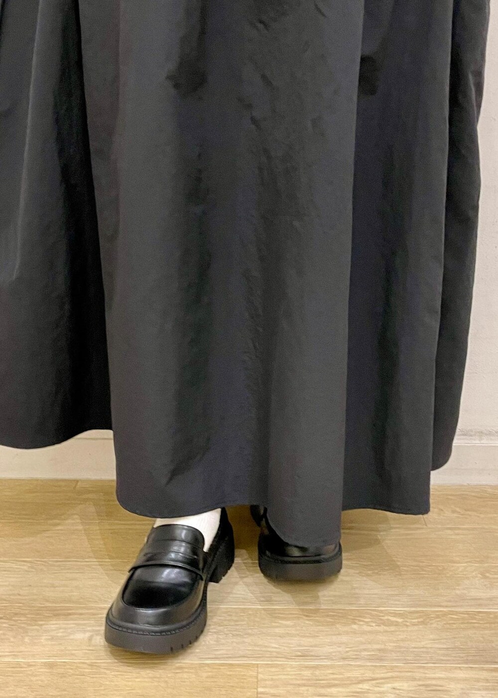 ブラック系のスカート、ブラック系のローファー、ブラック系のニット/セーターを着用したレディースの春コーディネートの5枚目の写真