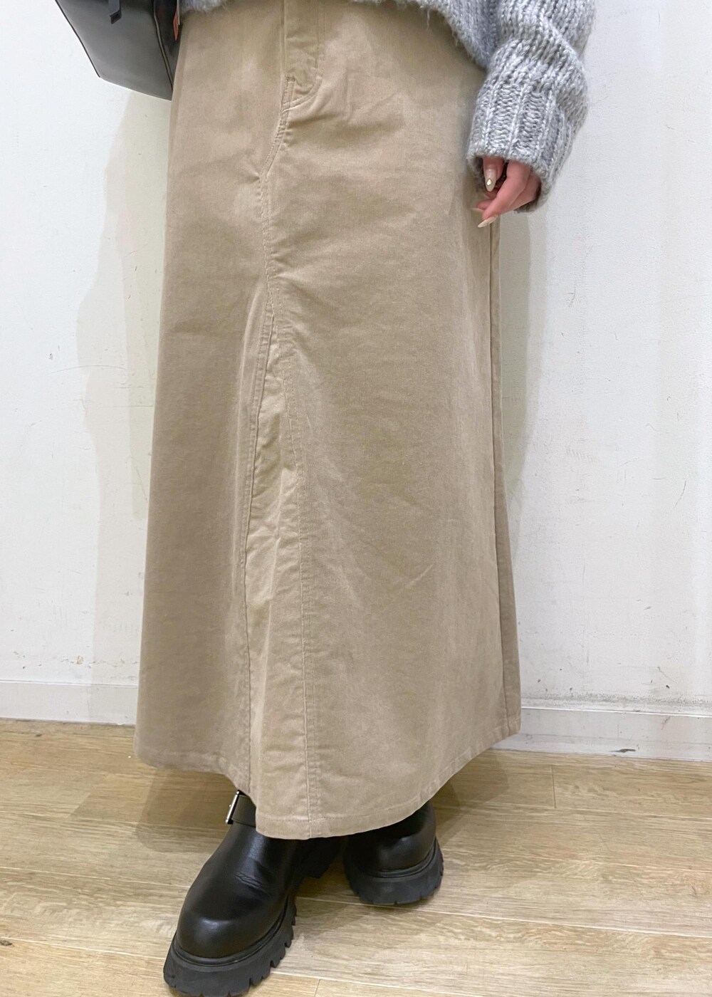 ホワイト系のTシャツ/カットソー、ブラック系のボストンバッグ、ベージュ系のスカートを着用したレディースの冬コーディネートの6枚目の写真