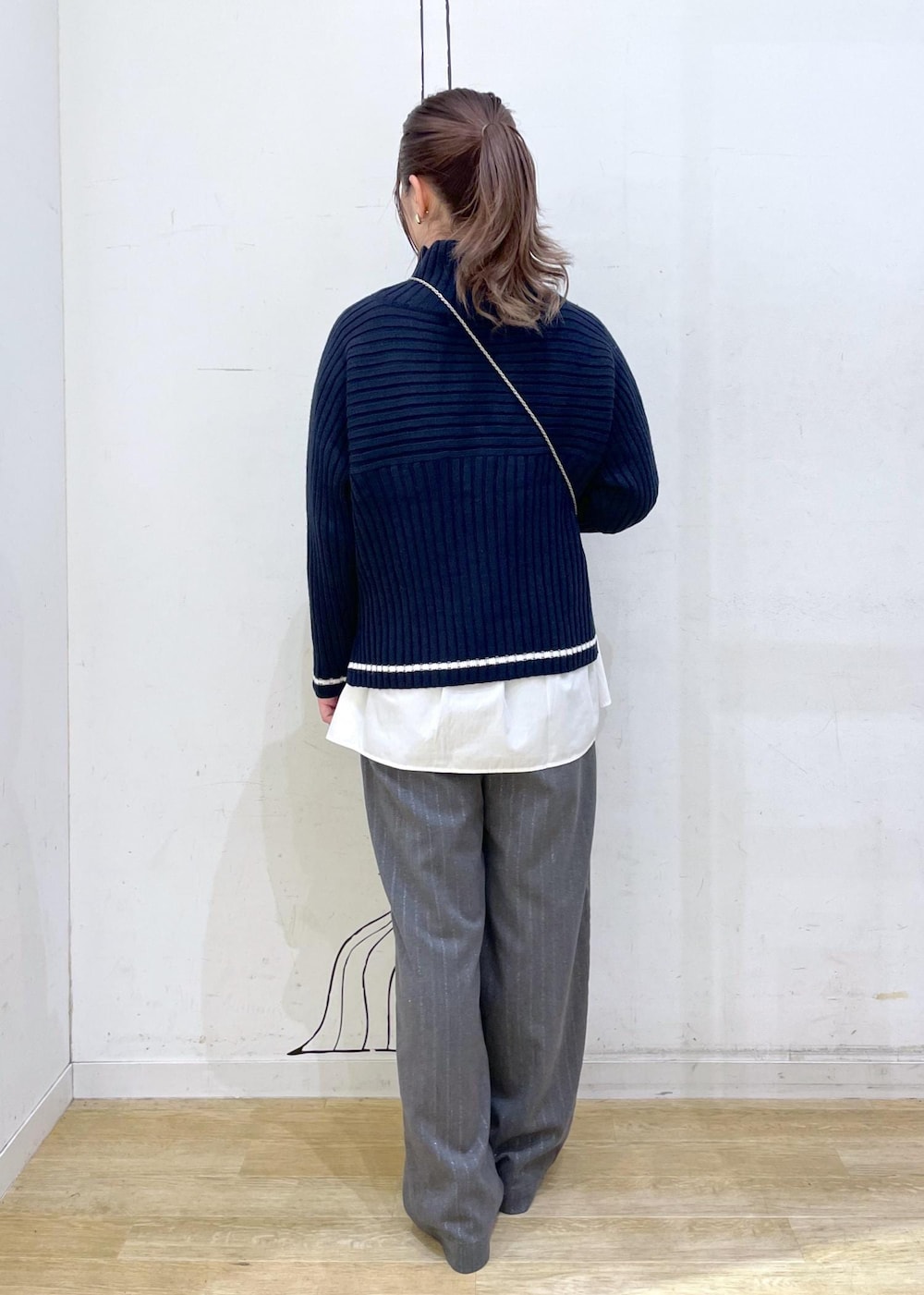 シルバー系のパンプス、ホワイト系のシャツ/ブラウス、ブルー系のニット/セーターを着用したレディースの秋コーディネートの2枚目の写真