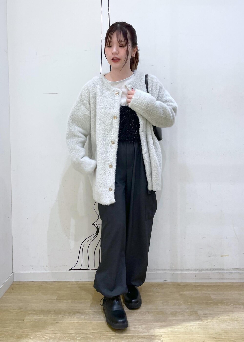ホワイト系のTシャツ/カットソー、ブラック系のベスト、ブラック系のショルダーバッグを着用したレディースの秋コーディネートの10枚目の写真