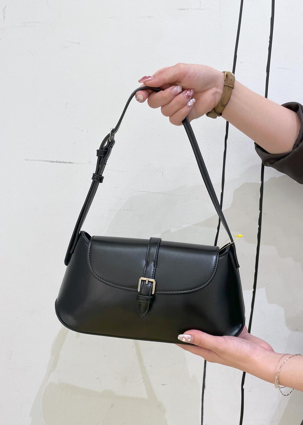 シルバー系のパンプス、ブルー系のデニムパンツ、ブラウン系のテーラードジャケットを着用したレディースの秋コーディネートの8枚目の写真