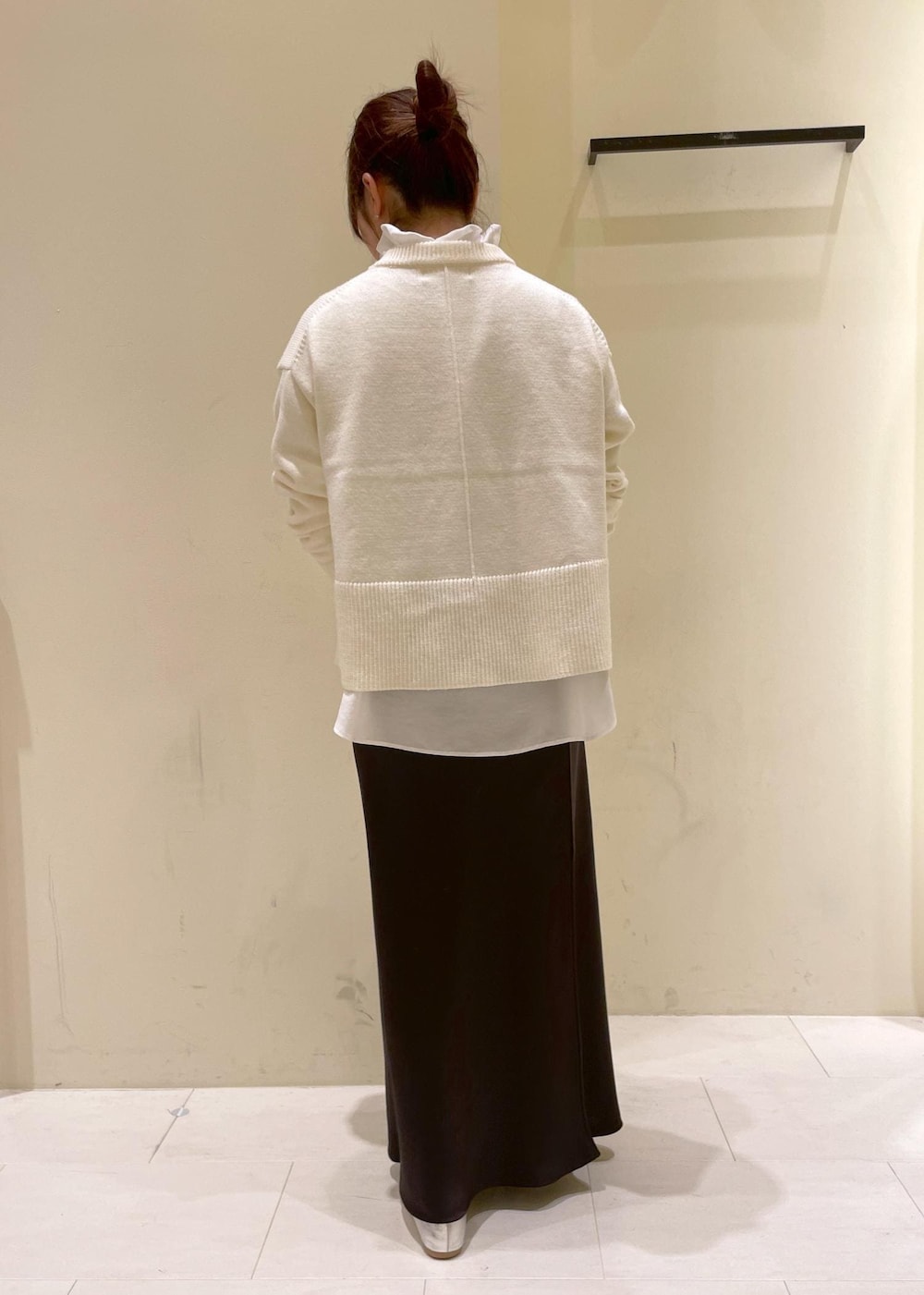 シルバー系のバレエシューズ、ホワイト系のニット/セーター、ホワイト系のトートバッグを着用したレディースの冬コーディネートの3枚目の写真