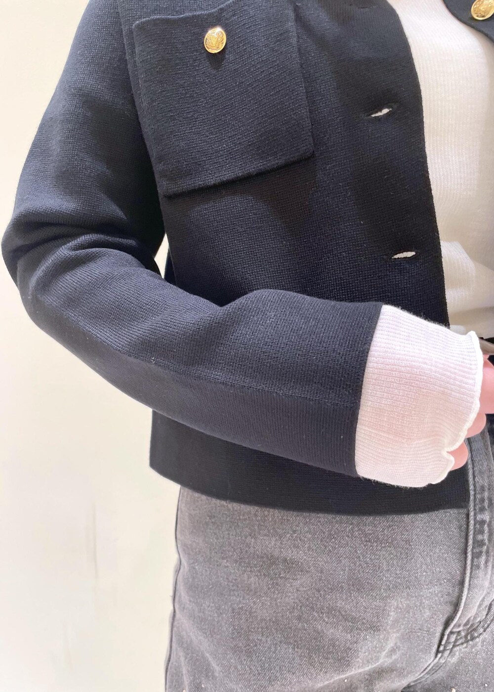 ブラック系のカーディガン/ボレロ、ホワイト系のTシャツ/カットソー、ブラック系のパンプスを着用したレディースの秋コーディネートの6枚目の写真