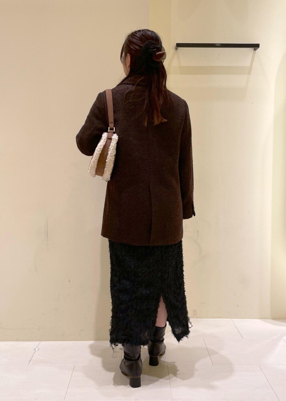 ホワイト系のカーディガン/ボレロ、ブラック系のブーツ、ブラウン系のテーラードジャケットを着用したレディースの秋コーディネートの3枚目の写真