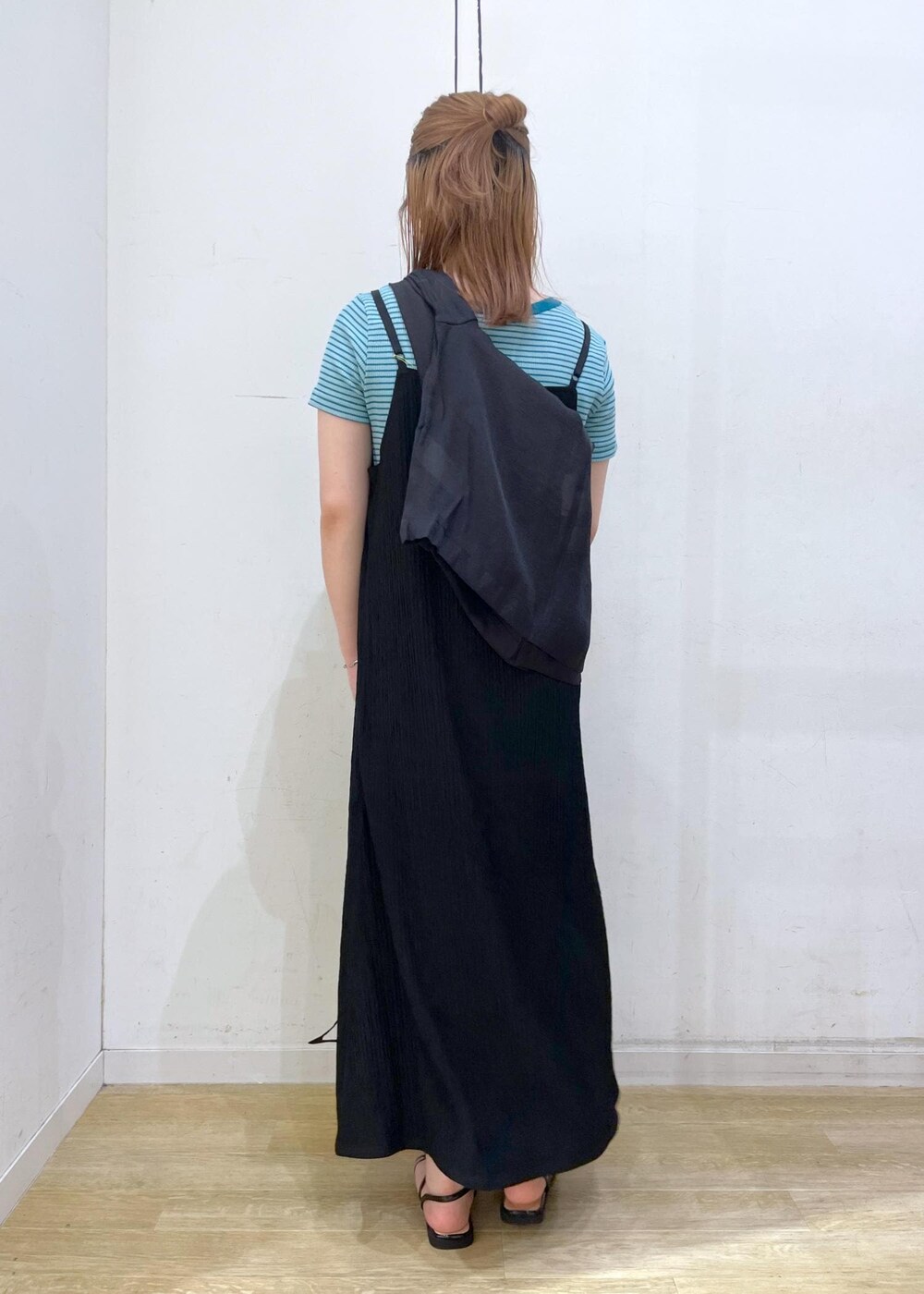 ブラック系のショルダーバッグ、ブラック系のサンダル、グリーン系のTシャツ/カットソーを着用したレディースの春コーディネートの2枚目の写真