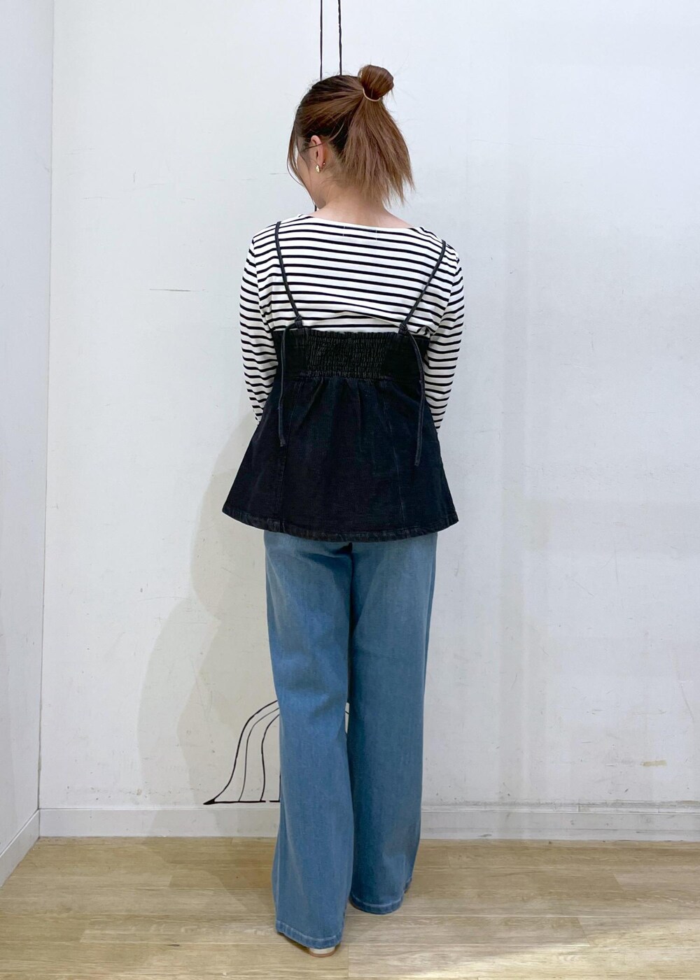 シルバー系のパンプス、ホワイト系のTシャツ/カットソー、ブラック系のベストを着用したレディースの秋コーディネートの2枚目の写真