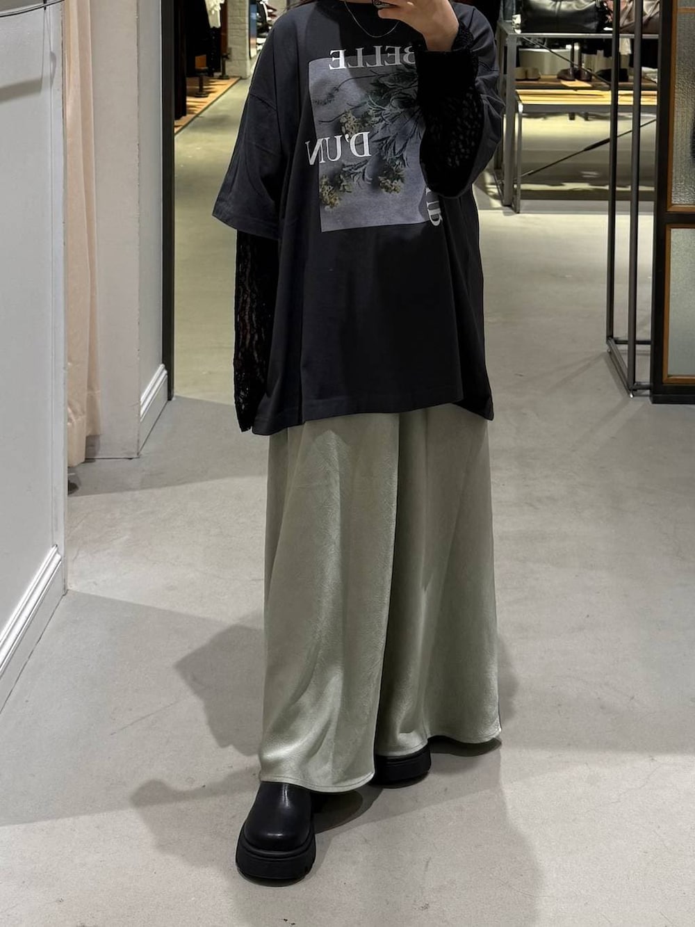 ブラック系のその他シューズ、グレー系のTシャツ/カットソー、グリーン系のスカートを着用したレディースの春コーディネートの3枚目の写真