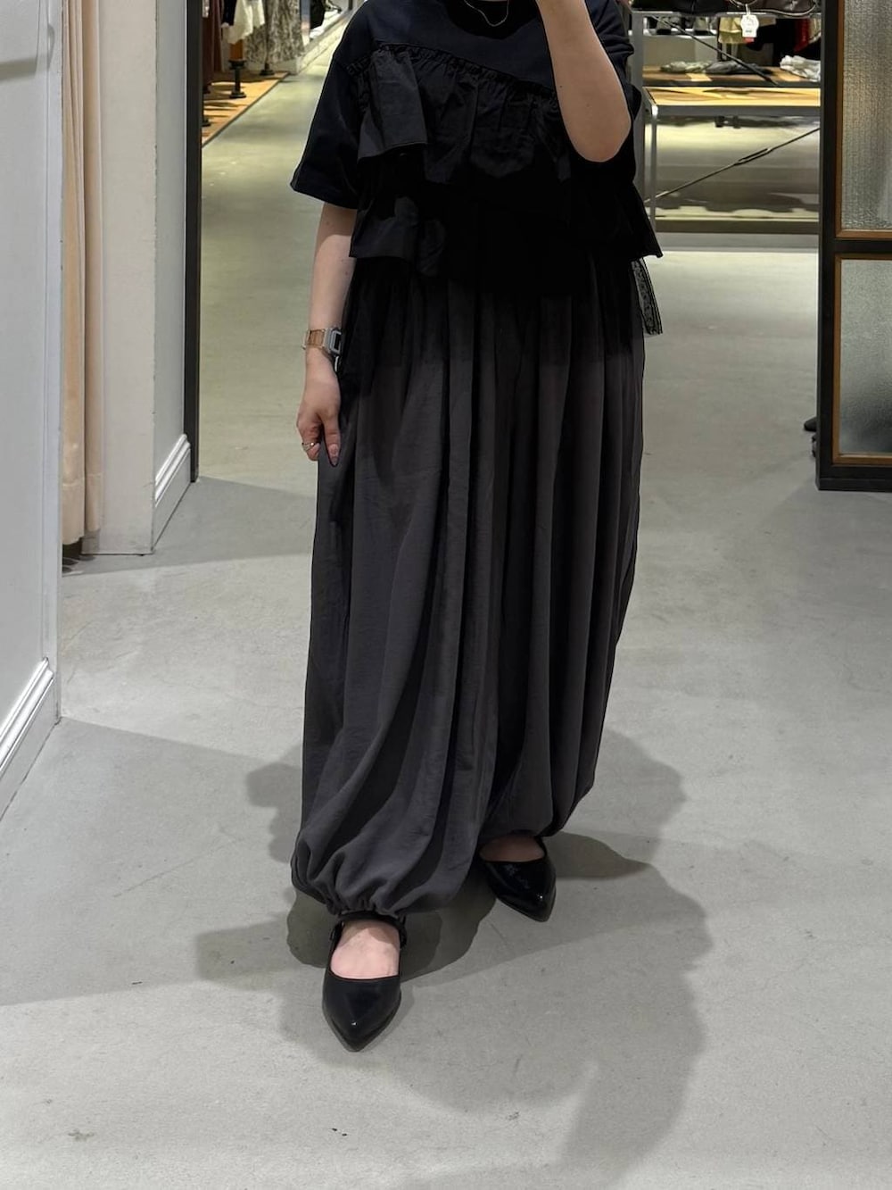 ブラック系のパンプス、グレー系のその他パンツ、ブラック系のTシャツ/カットソーを着用したレディースの春コーディネートの2枚目の写真