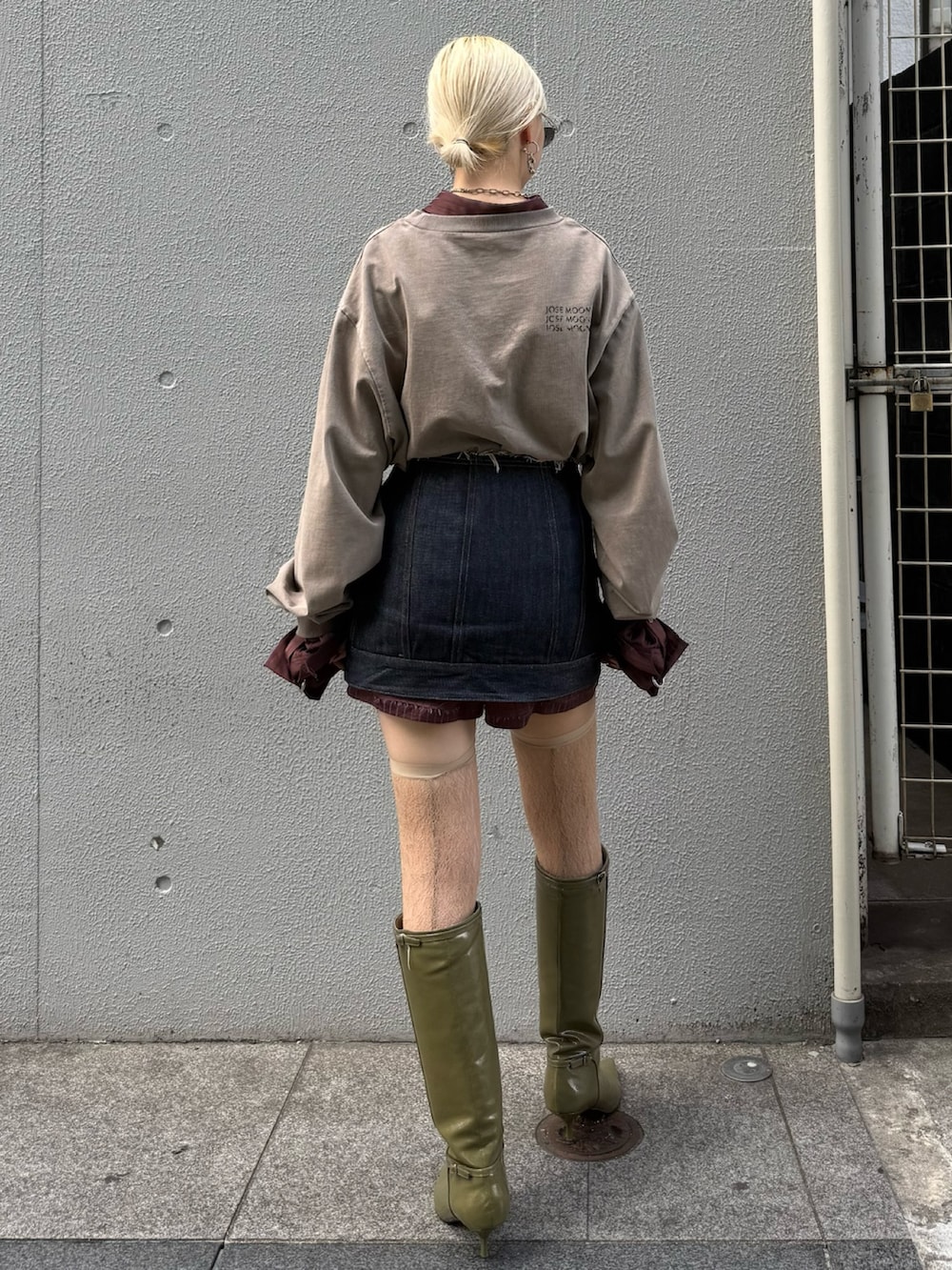 ブルー系のデニムスカート、ブラウン系のその他パンツ、グリーン系のブーツを着用したレディースの秋コーディネートの3枚目の写真