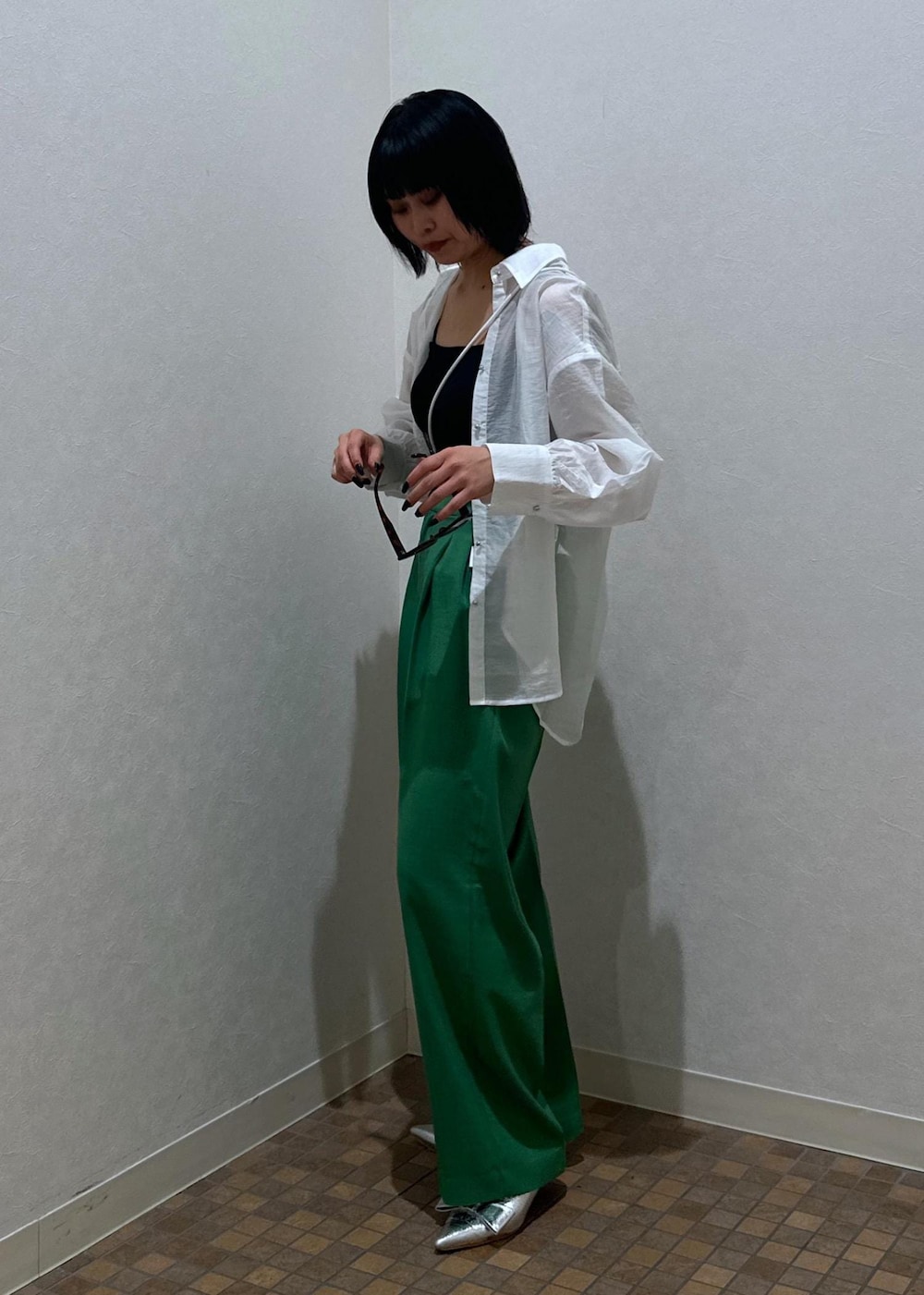 シルバー系のパンプス、ブラック系のキャミソール、グリーン系のスラックスを着用したレディースの夏コーディネートの4枚目の写真