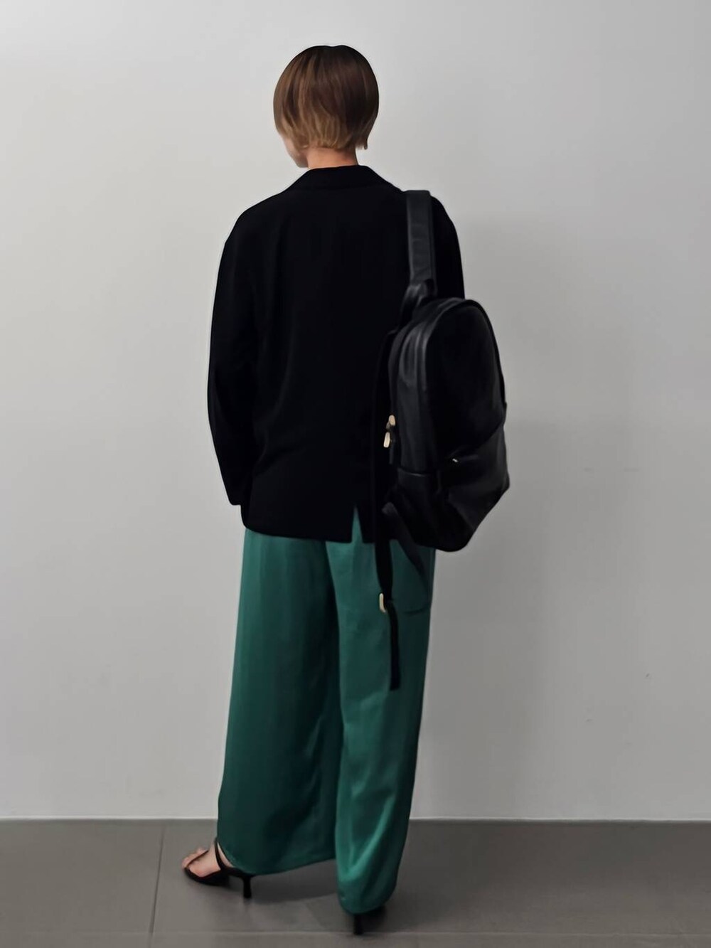 ブラック系のサンダル、グリーン系のその他パンツ、ブラック系のバックパック/リュックを着用したレディースの夏コーディネートの6枚目の写真