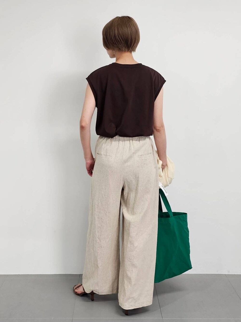 ホワイト系のカーディガン/ボレロ、ベージュ系のその他パンツ、ブラウン系のTシャツ/カットソーを着用したレディースの春コーディネートの6枚目の写真