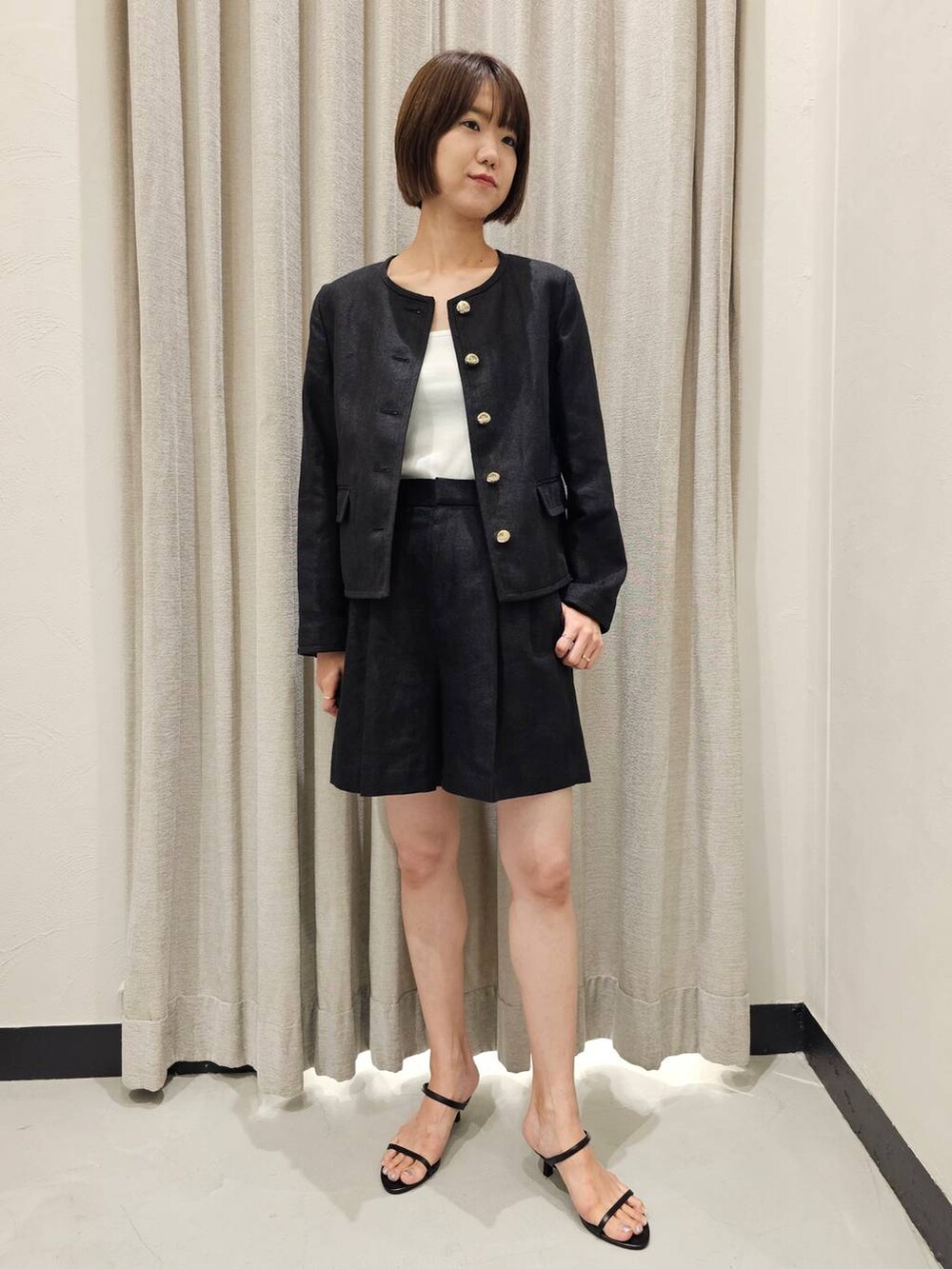 ブラック系のスリッポン、ブラック系のノーカラージャケット、ブラック系のその他パンツを着用したレディースの夏コーディネートの5枚目の写真