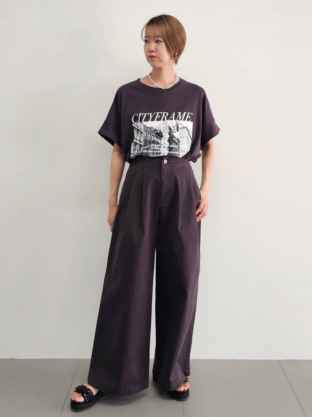 ブラック系のサンダル、グレー系のチノパンツ、ピンク系のシャツ/ブラウスを着用したレディースの夏コーディネートの5枚目の写真