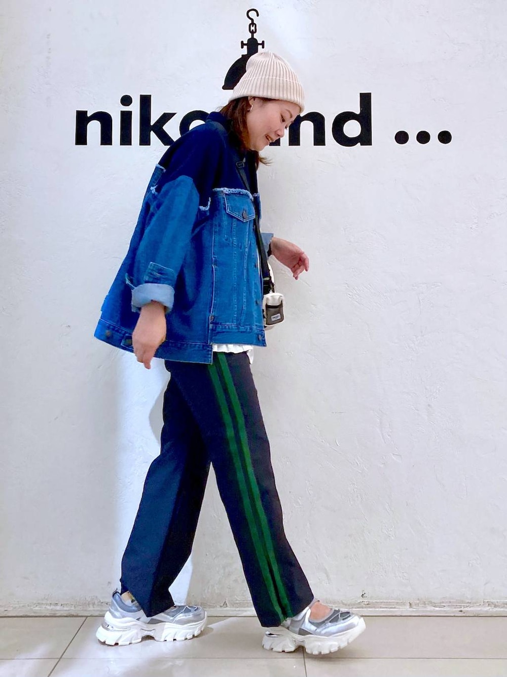 ブルー系のデニムジャケット、ブルー系のその他パンツ、シルバー系のスニーカーを着用したレディースの夏コーディネートの5枚目の写真