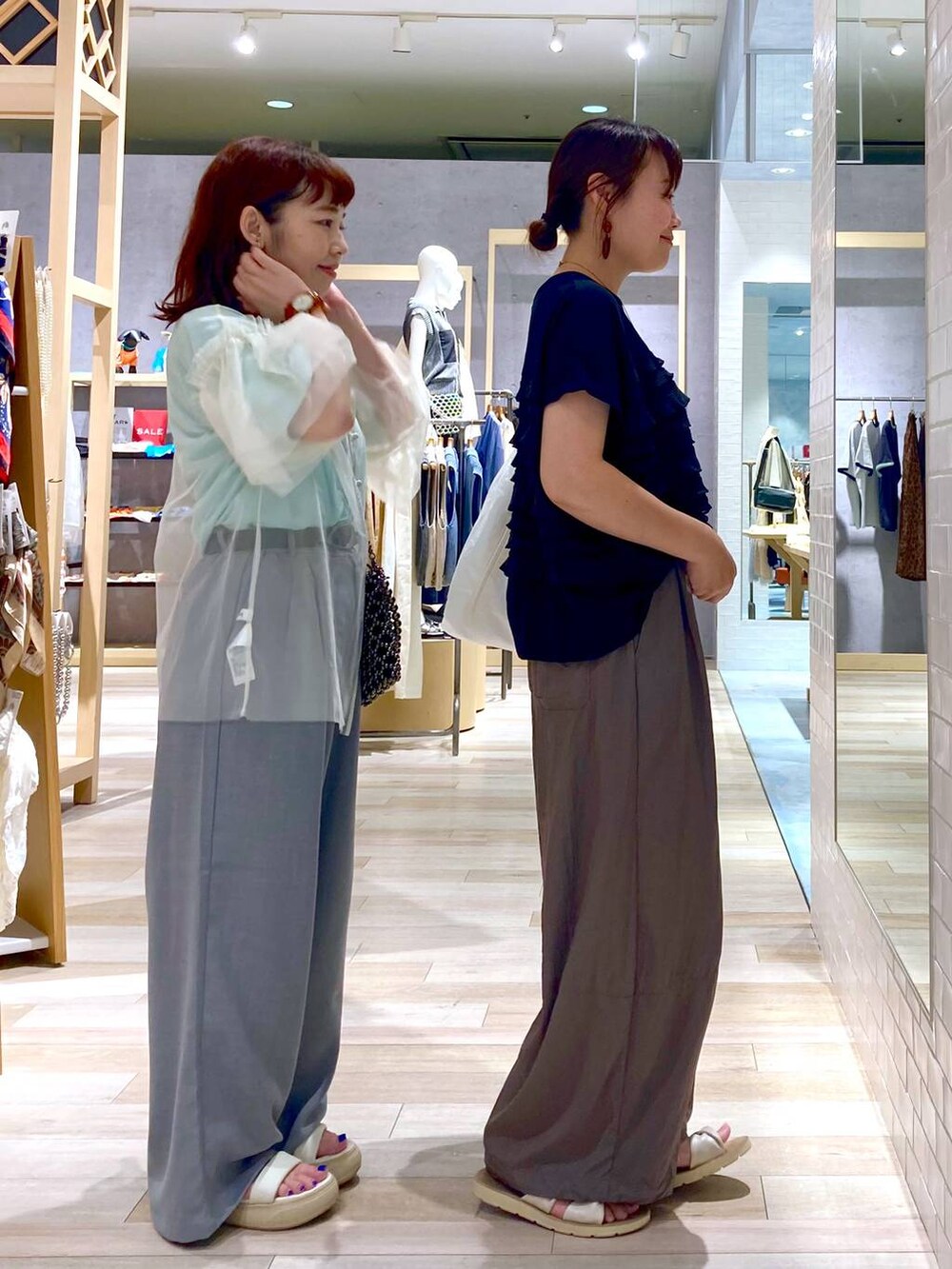 ブラック系のショルダーバッグ、ホワイト系のTシャツ/カットソー、ブラック系のTシャツ/カットソーを着用したレディースの夏コーディネートの4枚目の写真