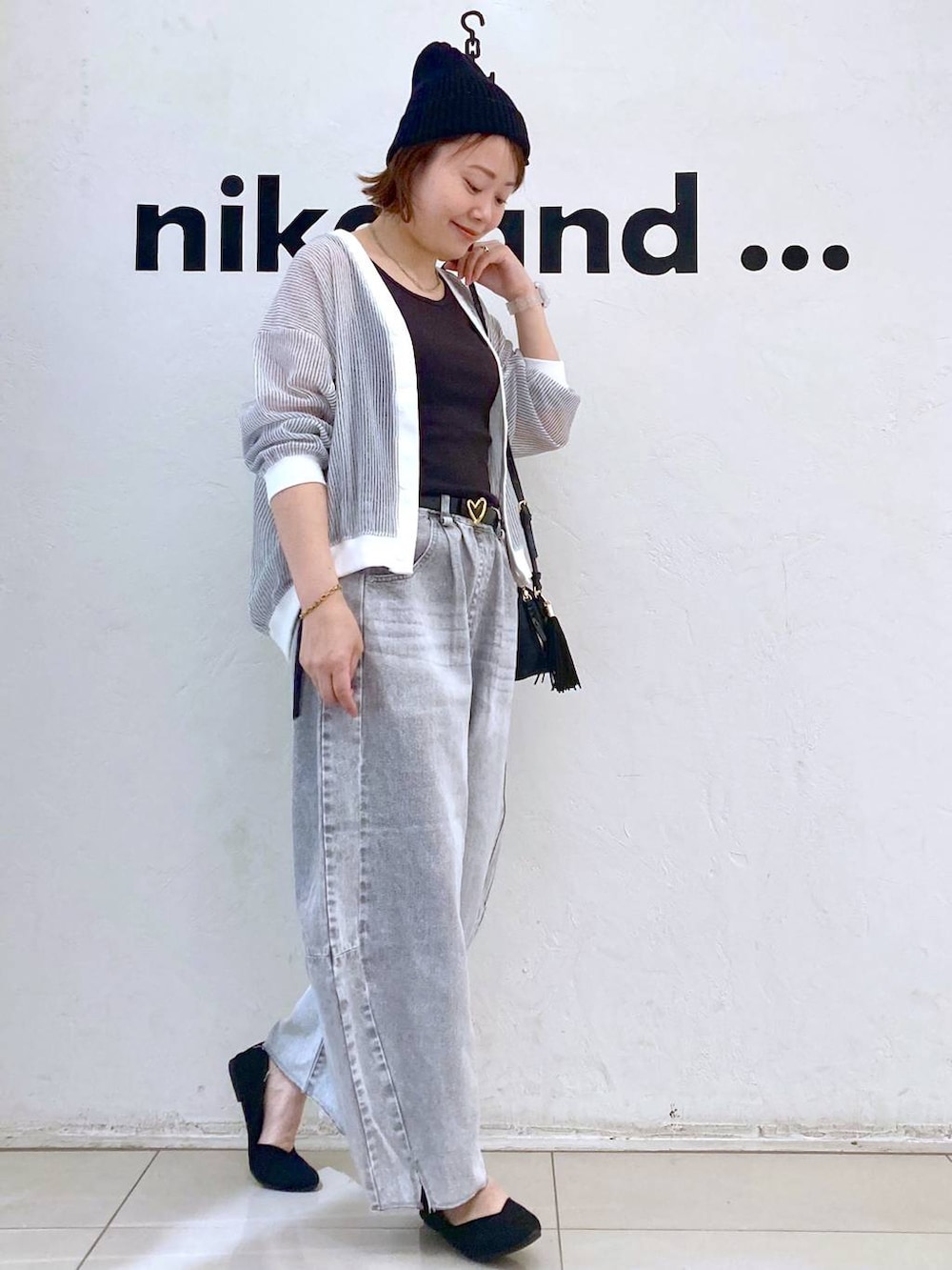 ホワイト系のカーディガン/ボレロ、グレー系のデニムパンツ、ブラック系のショルダーバッグを着用したレディースの春コーディネートの5枚目の写真