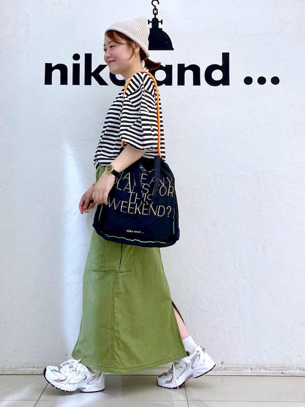 ホワイト系のスニーカー、その他のTシャツ/カットソー、グリーン系のスカートを着用したレディースの夏コーディネートの3枚目の写真