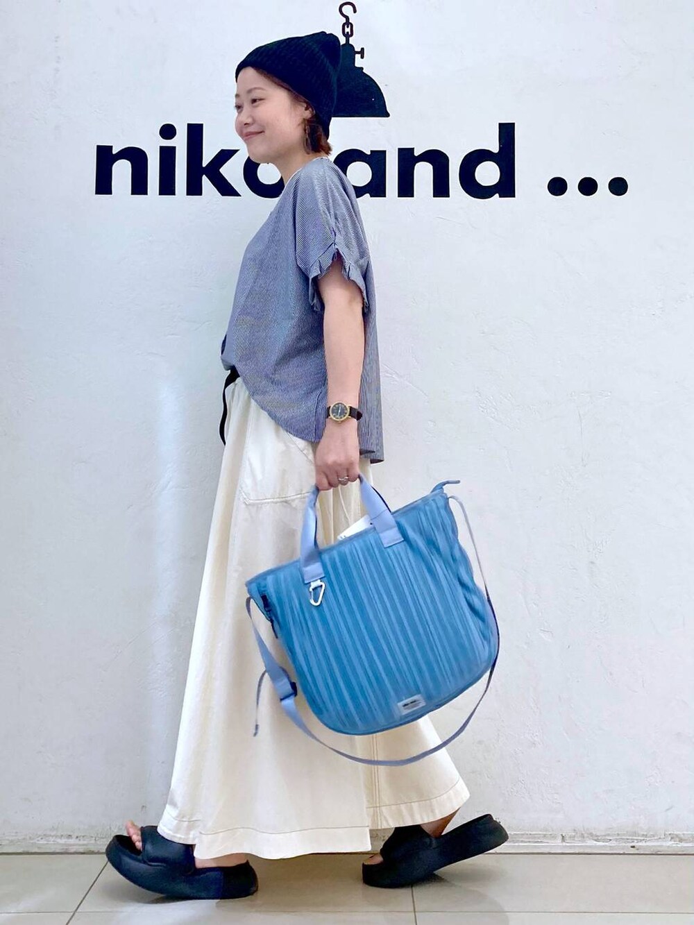 ブラック系のサンダル、ブルー系のTシャツ/カットソー、ブルー系のトートバッグを着用したレディースの夏コーディネートの5枚目の写真