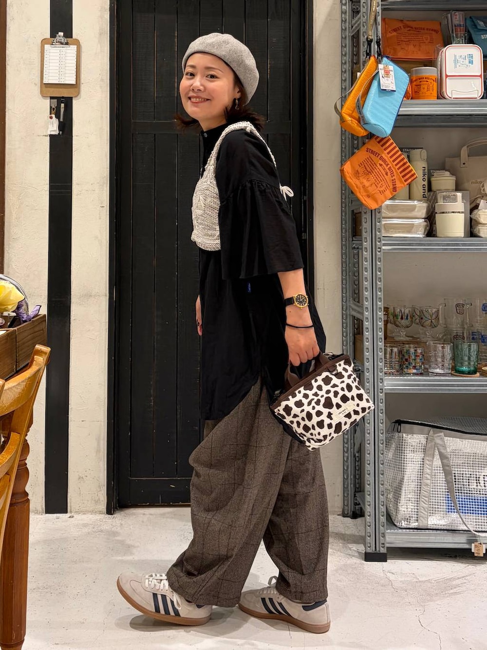 ホワイト系のベスト、ブラウン系のその他パンツ、その他のトートバッグを着用したレディースの秋コーディネートの2枚目の写真