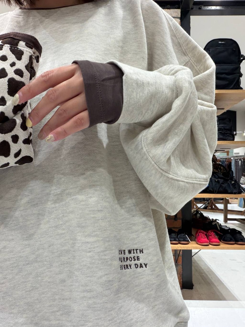 その他のトートバッグ、ブラウン系のデニムパンツ、ベージュ系のスウェットを着用したレディースの秋コーディネートの6枚目の写真