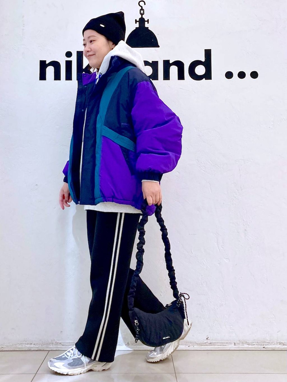 ブラック系のその他パンツ、パープル系のその他アウター、ブラック系のショルダーバッグを着用したレディースの冬コーディネートの3枚目の写真