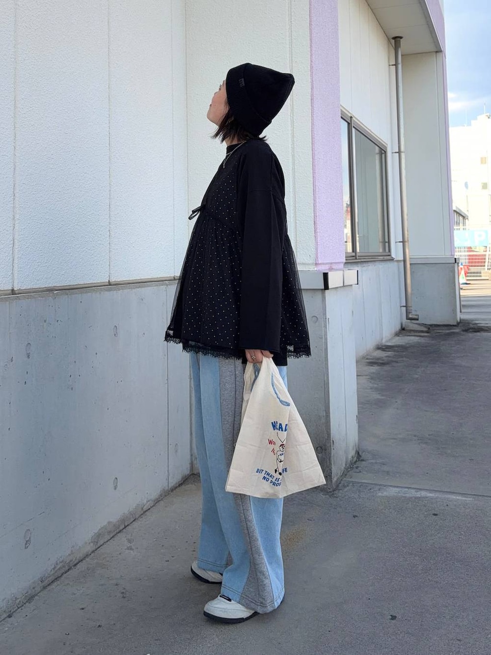 グレー系のデニムパンツ、ブラック系のTシャツ/カットソー、ブラック系のベストを着用したレディースの春コーディネートの3枚目の写真