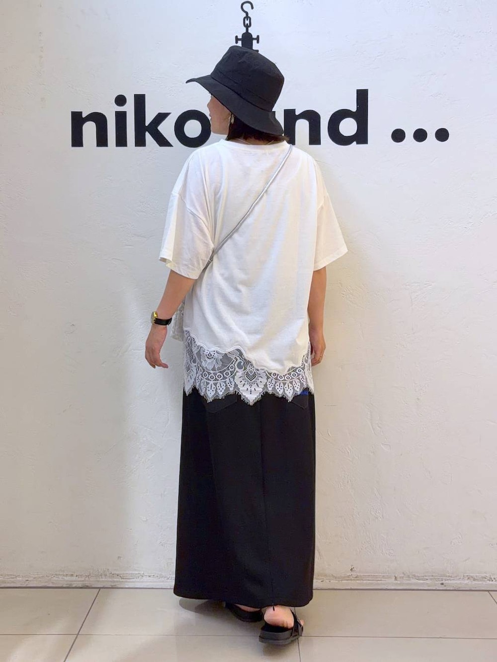 ホワイト系のショルダーバッグ、ホワイト系のTシャツ/カットソー、ブラック系のハットを着用したレディースの夏コーディネートの3枚目の写真