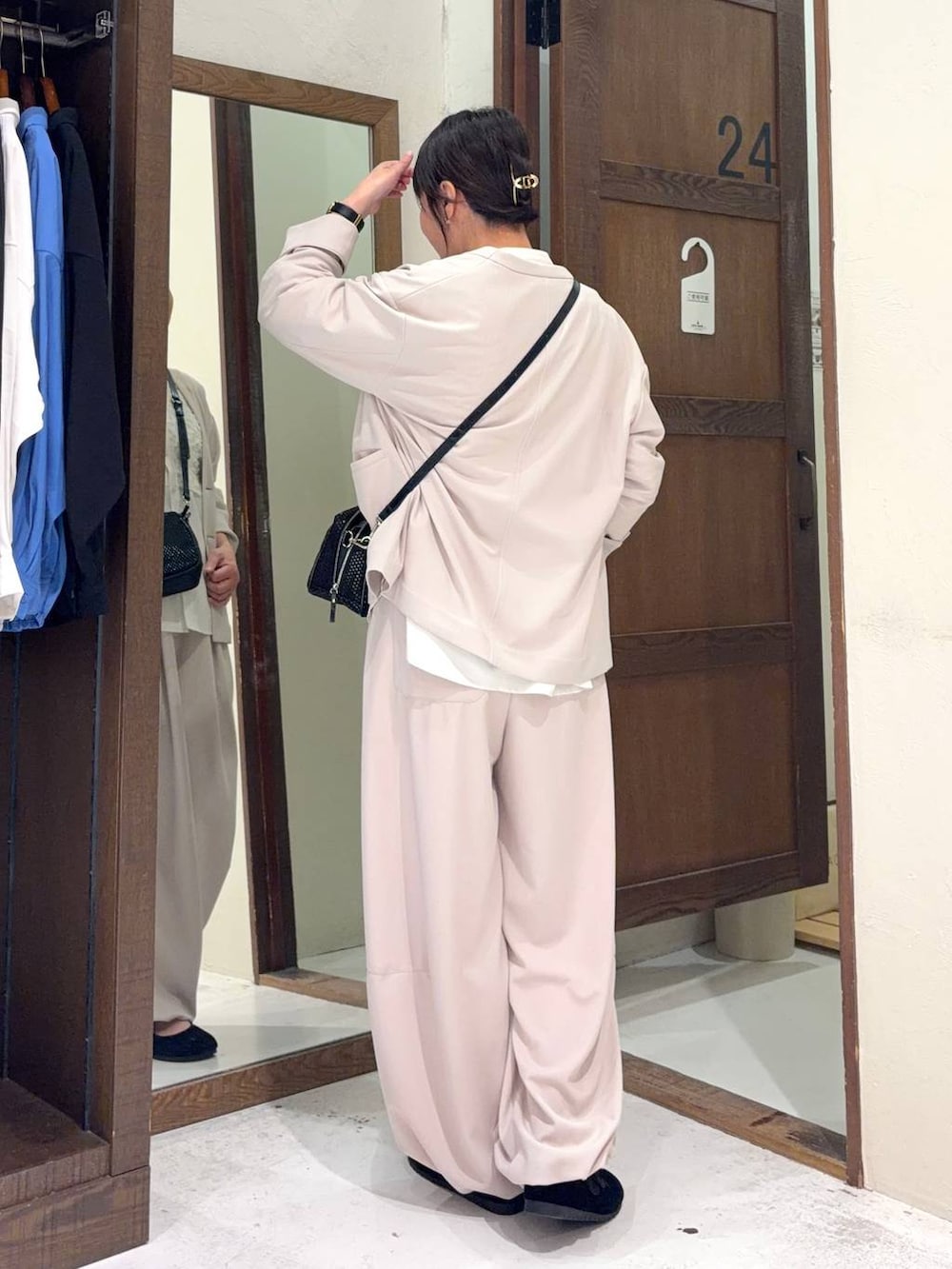 ブラック系のパンプス、ホワイト系のシャツ/ブラウス、その他のショルダーバッグを着用したレディースの冬コーディネートの5枚目の写真