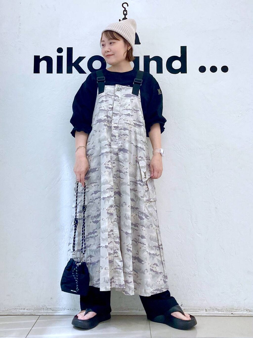 ブラック系のショルダーバッグ、ブラック系のサンダル、ブラック系のTシャツ/カットソーを着用したレディースの春コーディネートの2枚目の写真