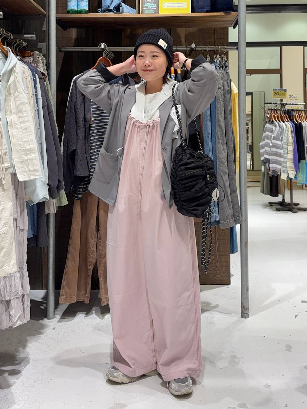 ピンク系のサロペット/オーバーオール、ホワイト系のパーカー、ブラック系のバックパック/リュックを着用したレディースの春コーディネートの2枚目の写真