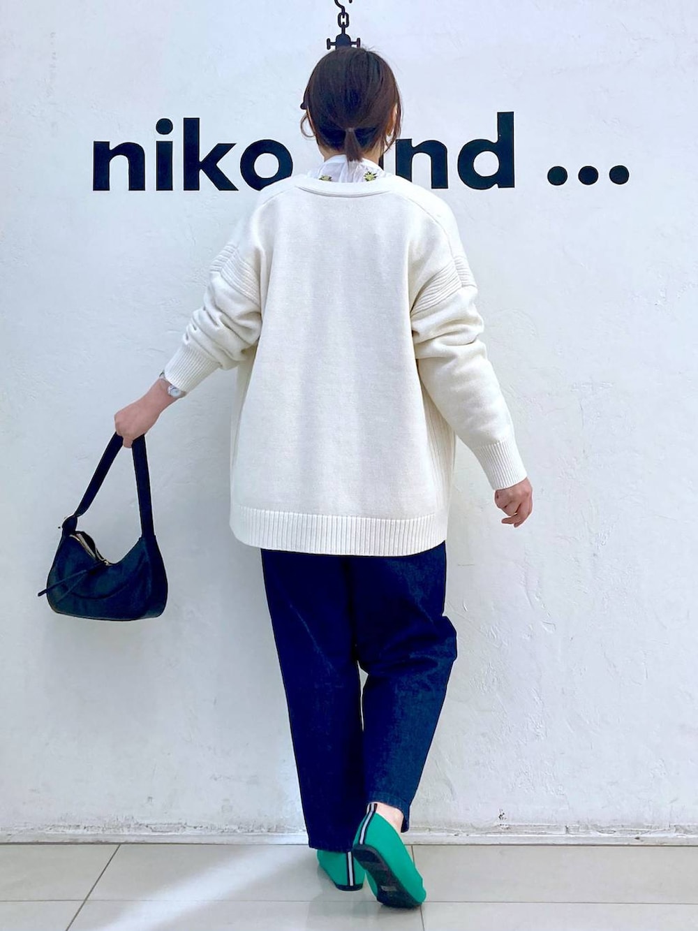 ブラック系のショルダーバッグ、ホワイト系のシャツ/ブラウス、グリーン系のパンプスを着用したレディースの春コーディネートの4枚目の写真