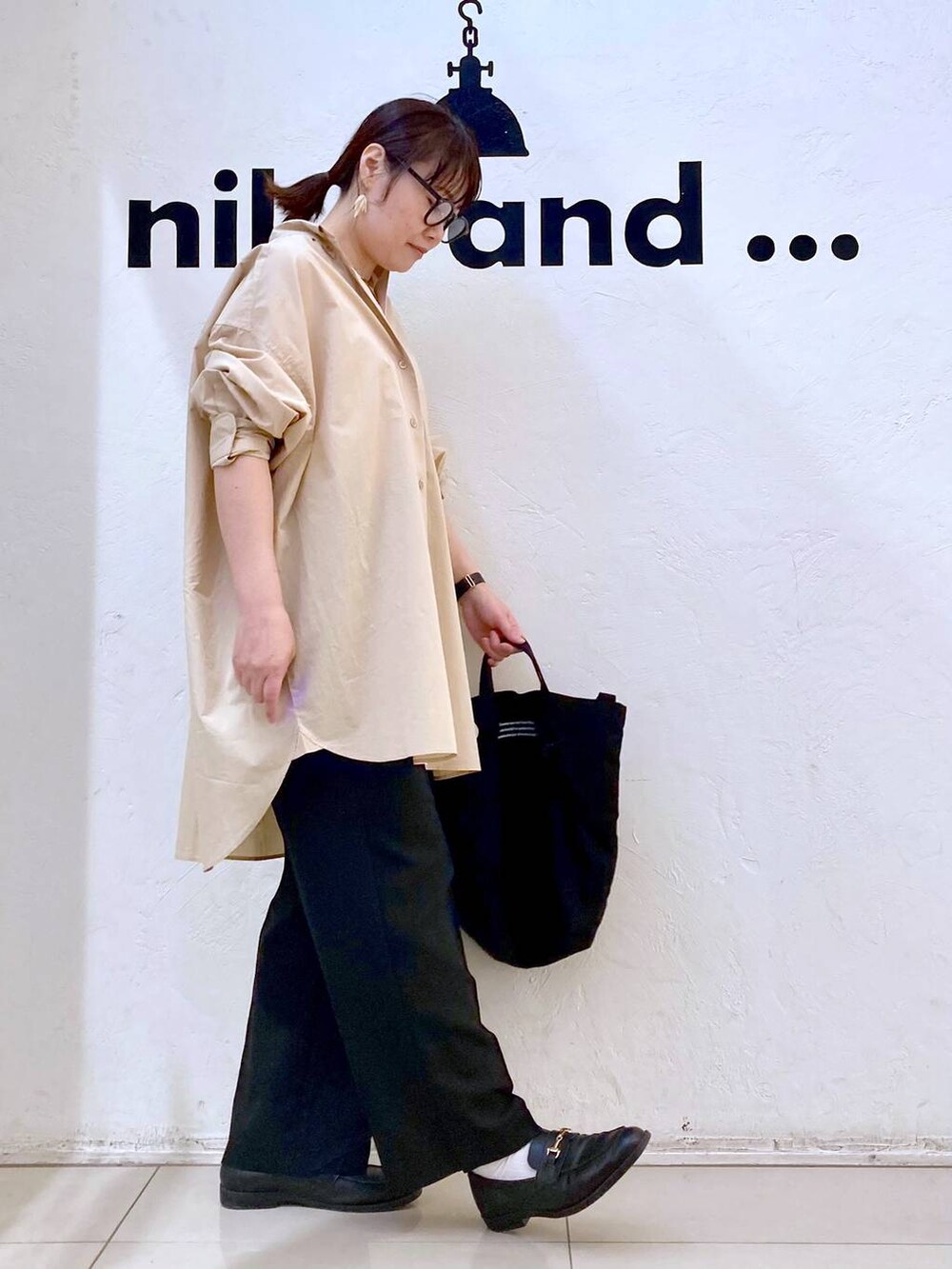 ブラック系のトートバッグ、ブラック系のその他パンツ、ベージュ系のシャツ/ブラウスを着用したレディースの春コーディネートの5枚目の写真
