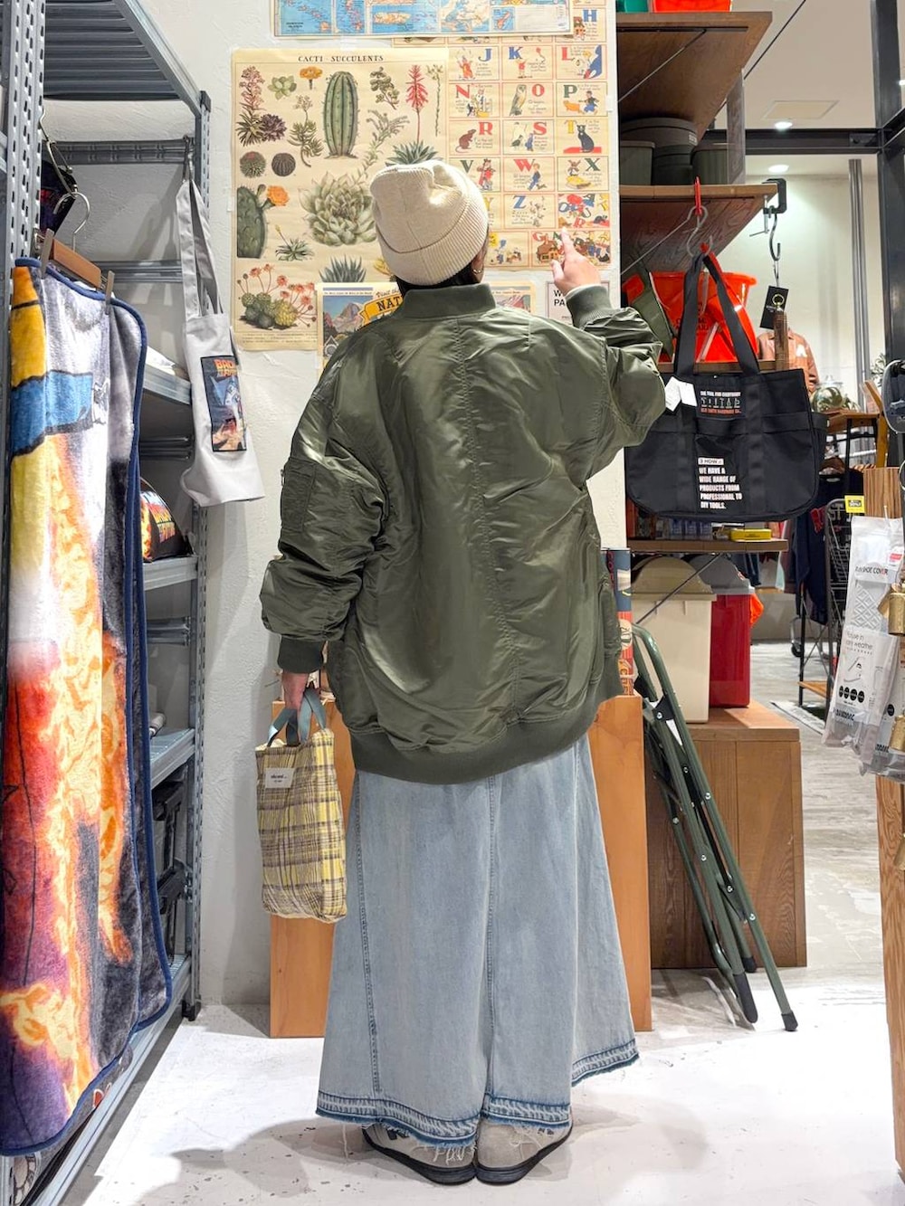 ホワイト系のTシャツ/カットソー、グリーン系のMA-1、イエロー系のトートバッグを着用したレディースの冬コーディネートの4枚目の写真