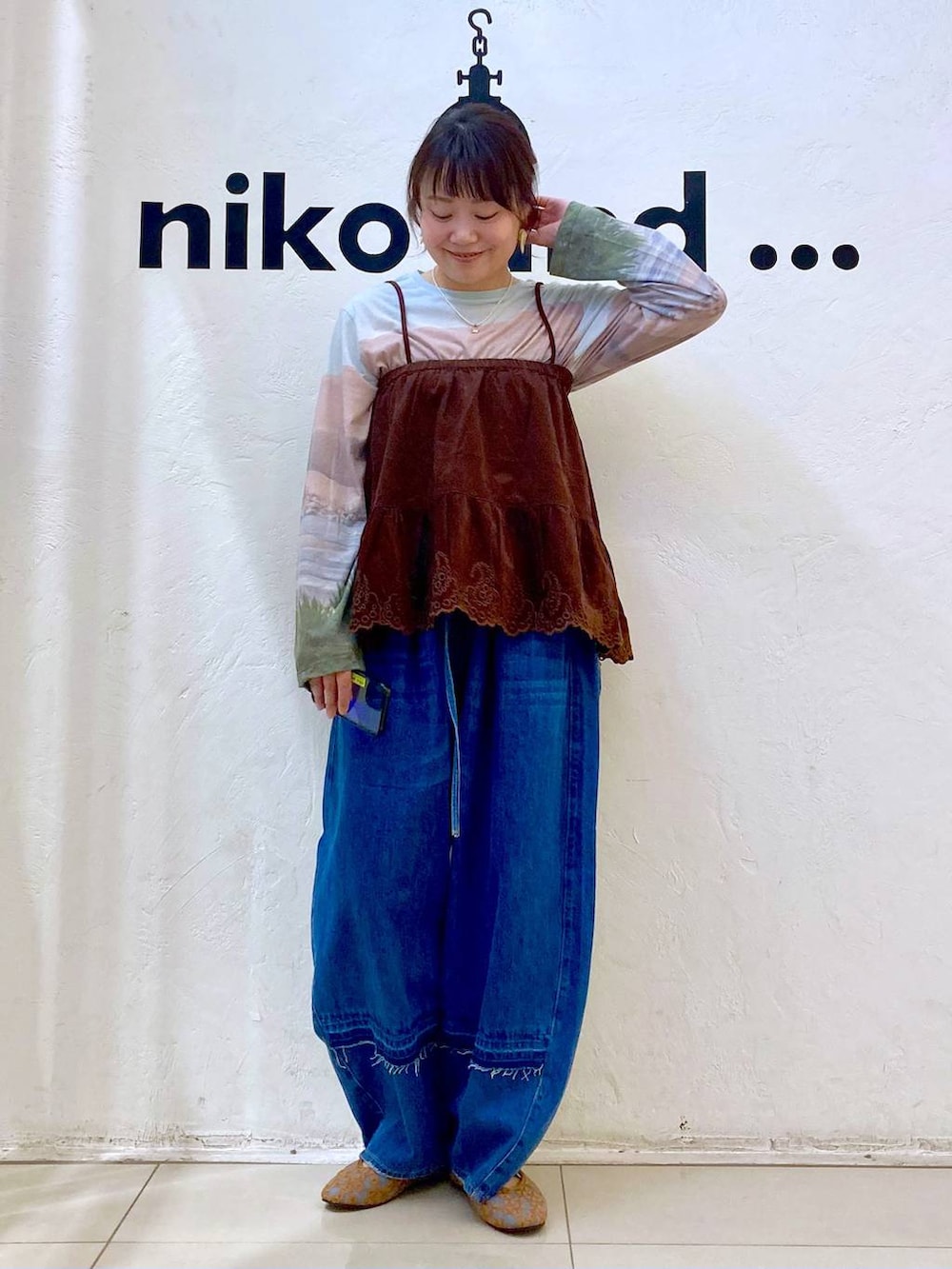 ブラウン系のパンプス、ベージュ系のTシャツ/カットソー、ブルー系のデニムパンツを着用したレディースの夏コーディネートの2枚目の写真