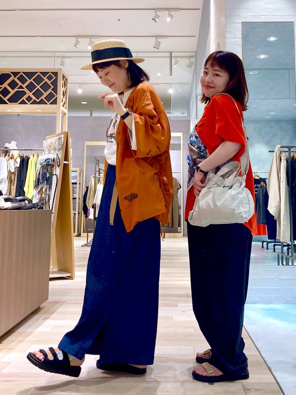 ブルー系のその他パンツ、レッド系のシャツ/ブラウス、ブラック系のサンダルを着用したレディースの春コーディネートの5枚目の写真