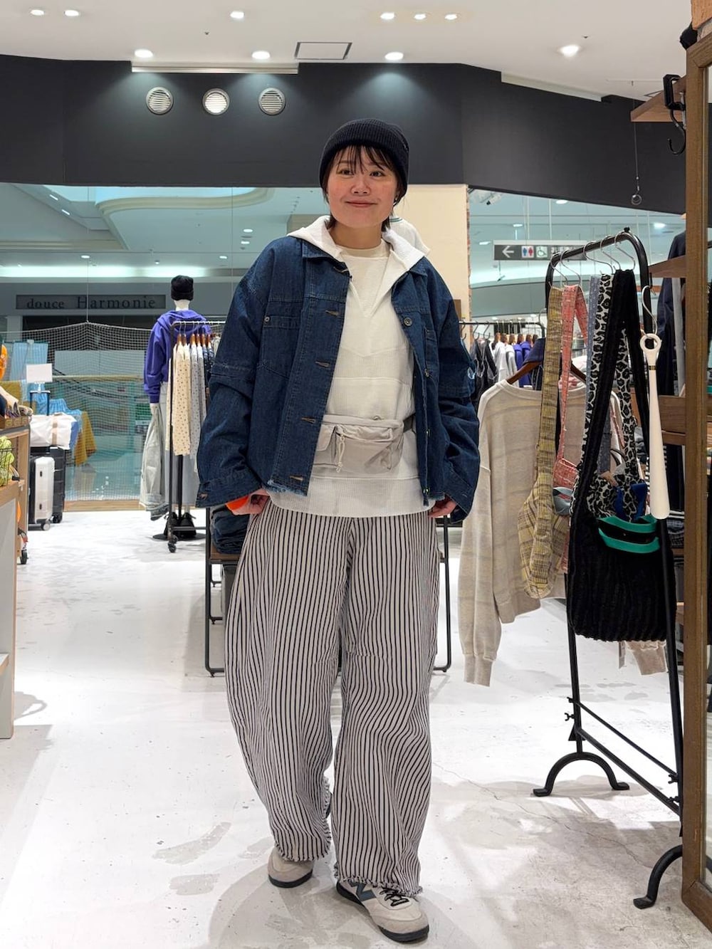 ホワイト系のデニムパンツ、ホワイト系のパーカー、ベージュ系のニット/セーターを着用したレディースの冬コーディネートの2枚目の写真